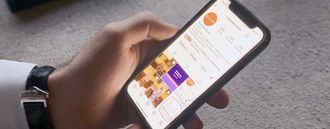 A hand holding a phone. On screen is The Globe Church's Instagram account.