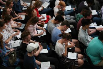 People
    looking reading the Bible at a church service